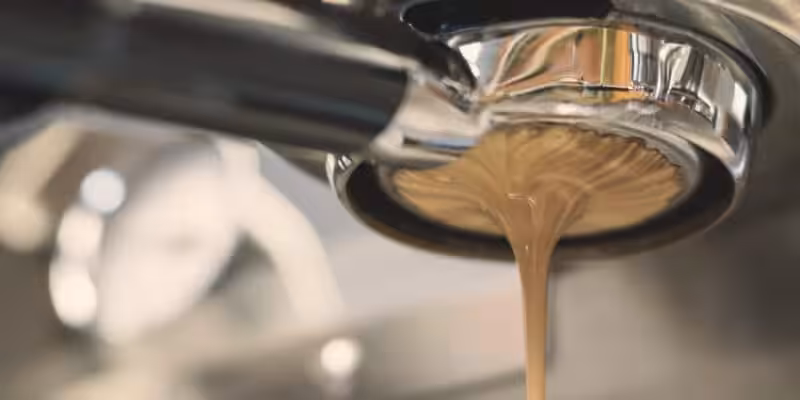 Coffee being made in coffee shop equipment.