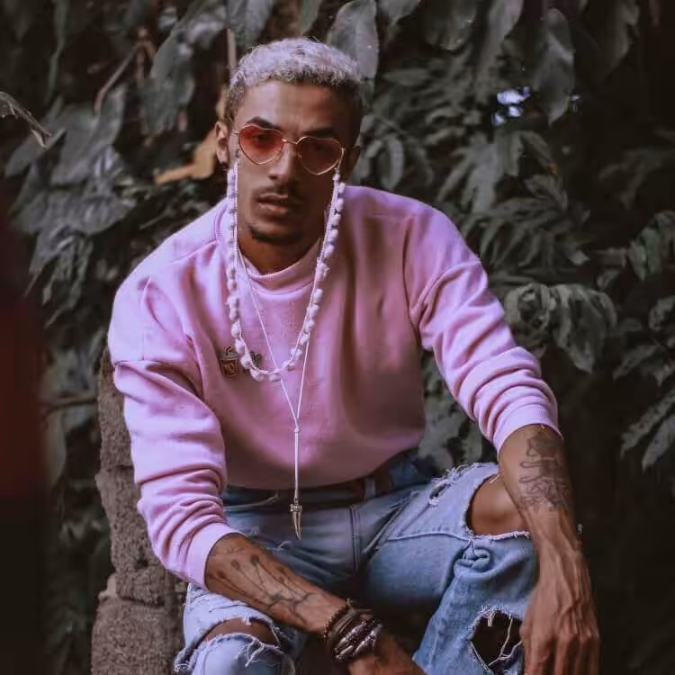 a fashionable man looking front on at the camera.