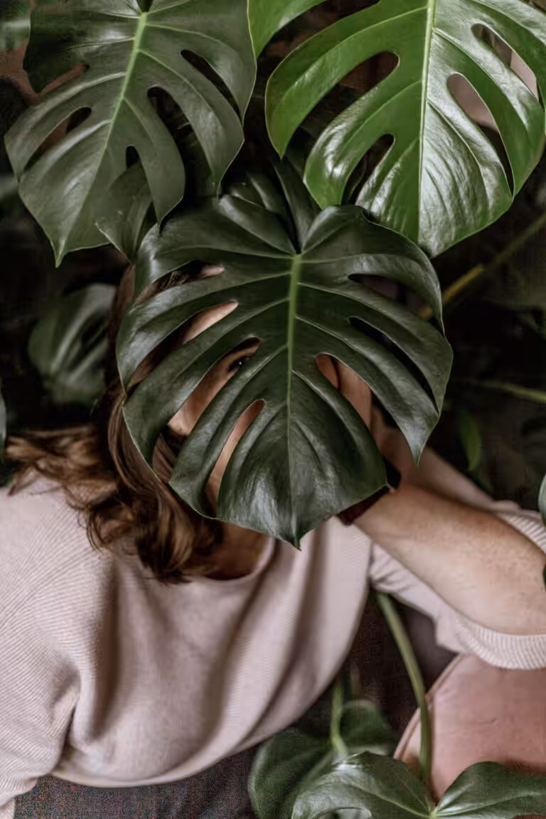 Aime hiding behind a plant. She's a proper businesswoman we promise.
