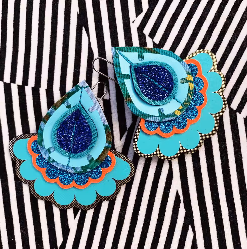 Before photography makeover shot of Dakota Rae Dust - geometric earrings on geometric background.