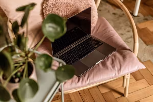 Laptop on a pink cushion inside Studio Cotton
