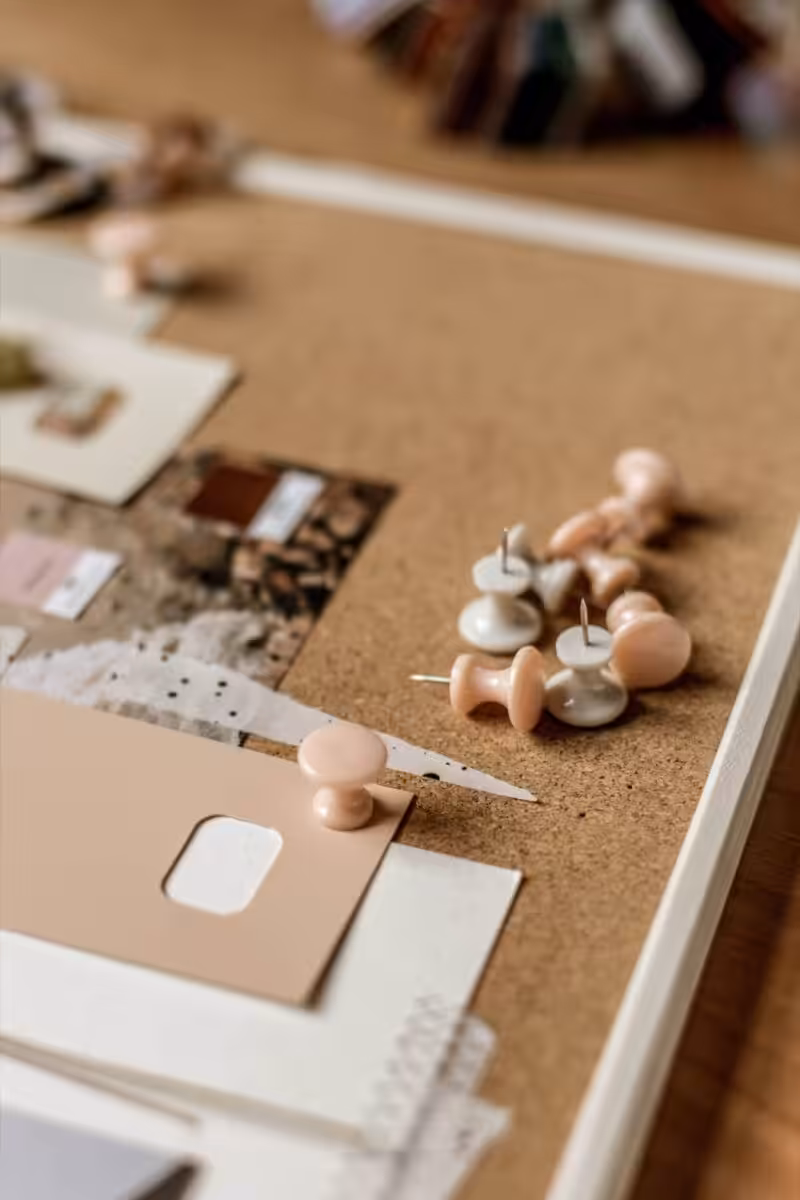 Some pins on a Studio Cotton cork board for planning out a collaborative branding project 