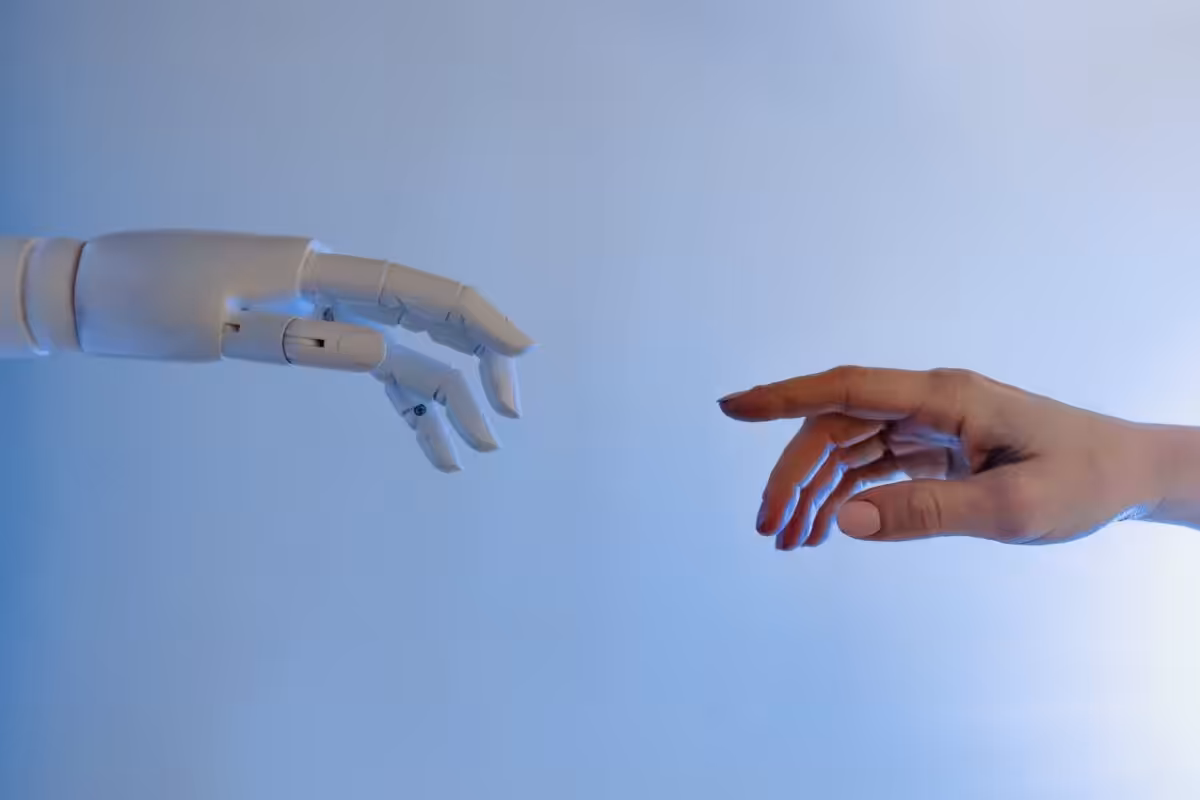 A human hand reaching for a robot hand.