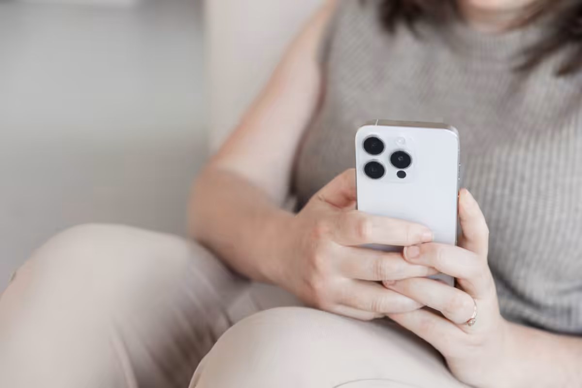A close up on an Apple iPhone being used by Aime from Studio Cotton.