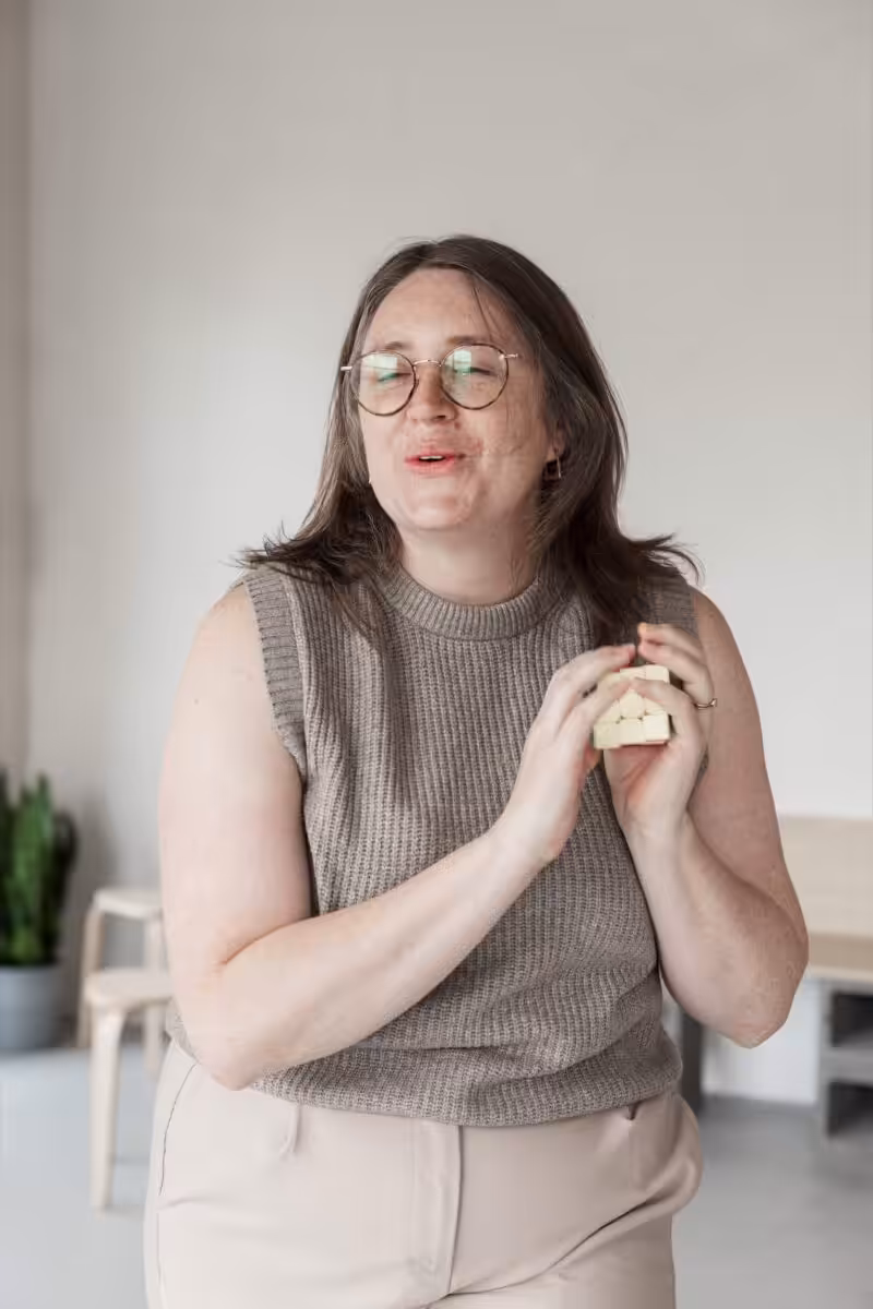 Studio Cotton founder Aime holding a rubiks cube.