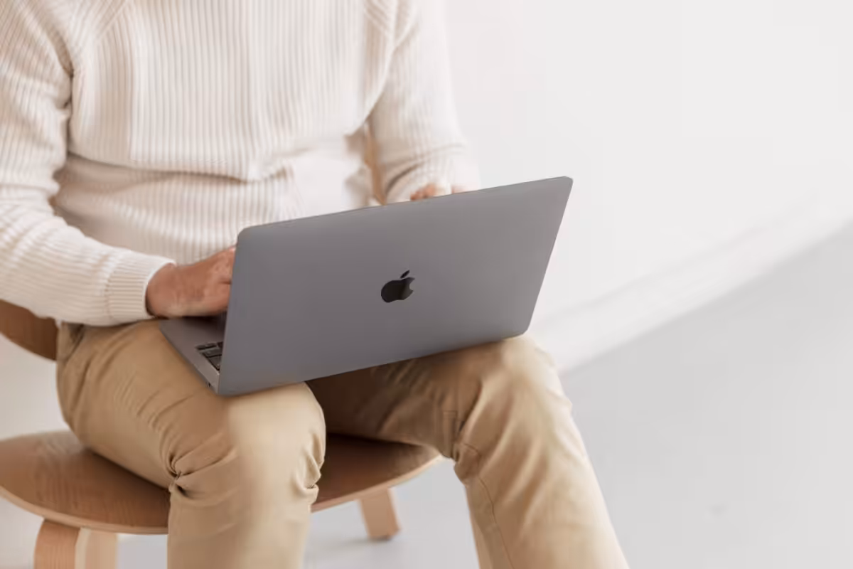 Cai using a laptop as a generic About page image.