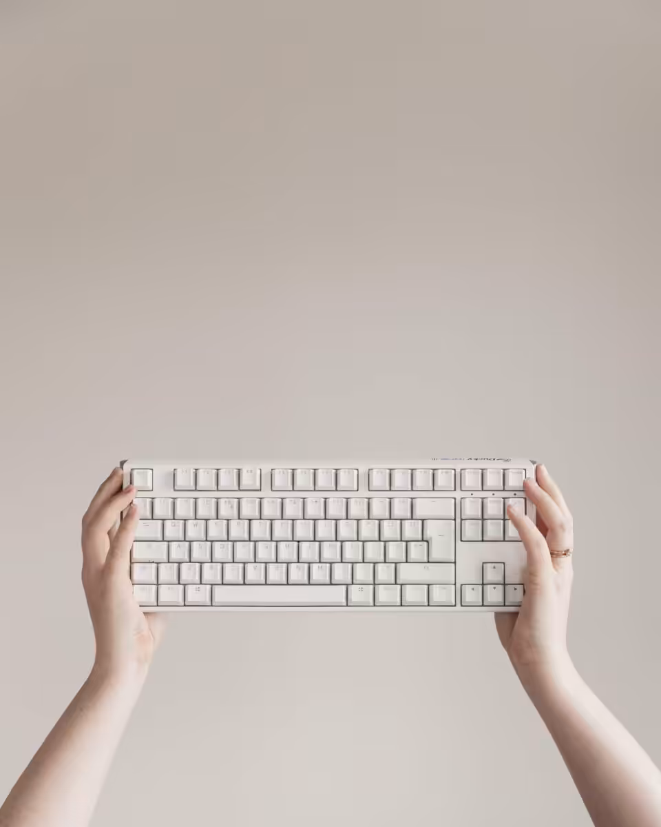 Hands holding a keyboard.