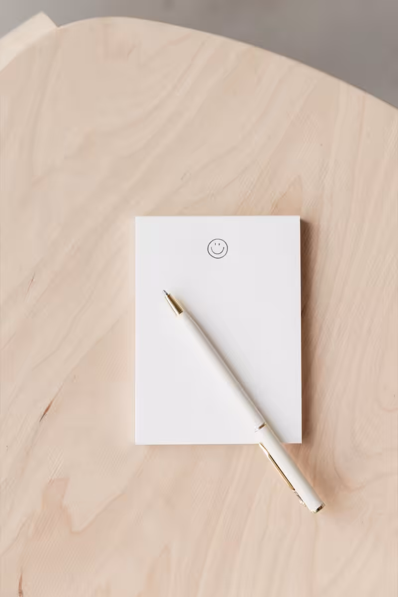 A smiley faced notebook to list all your website dealbreakers.