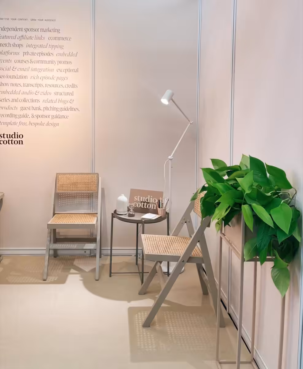 The Studio Cotton stand at The Podcast Show, some text on the wall explaining our podcast website service.