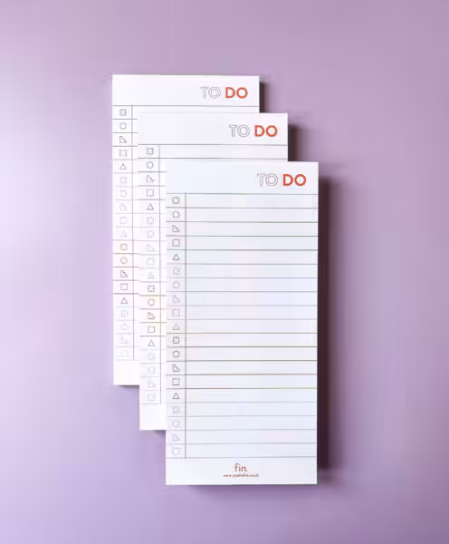 3 to do notepads stacked on a purple background