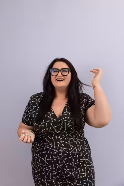 Bonnie of Words by Bonnie laughs at the middle distance with a lilac background