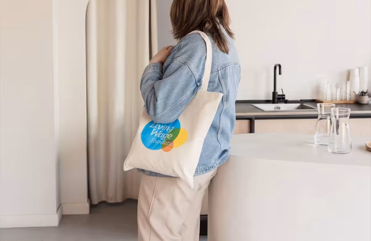 Carrying a tote bag from Living Wage Foundation